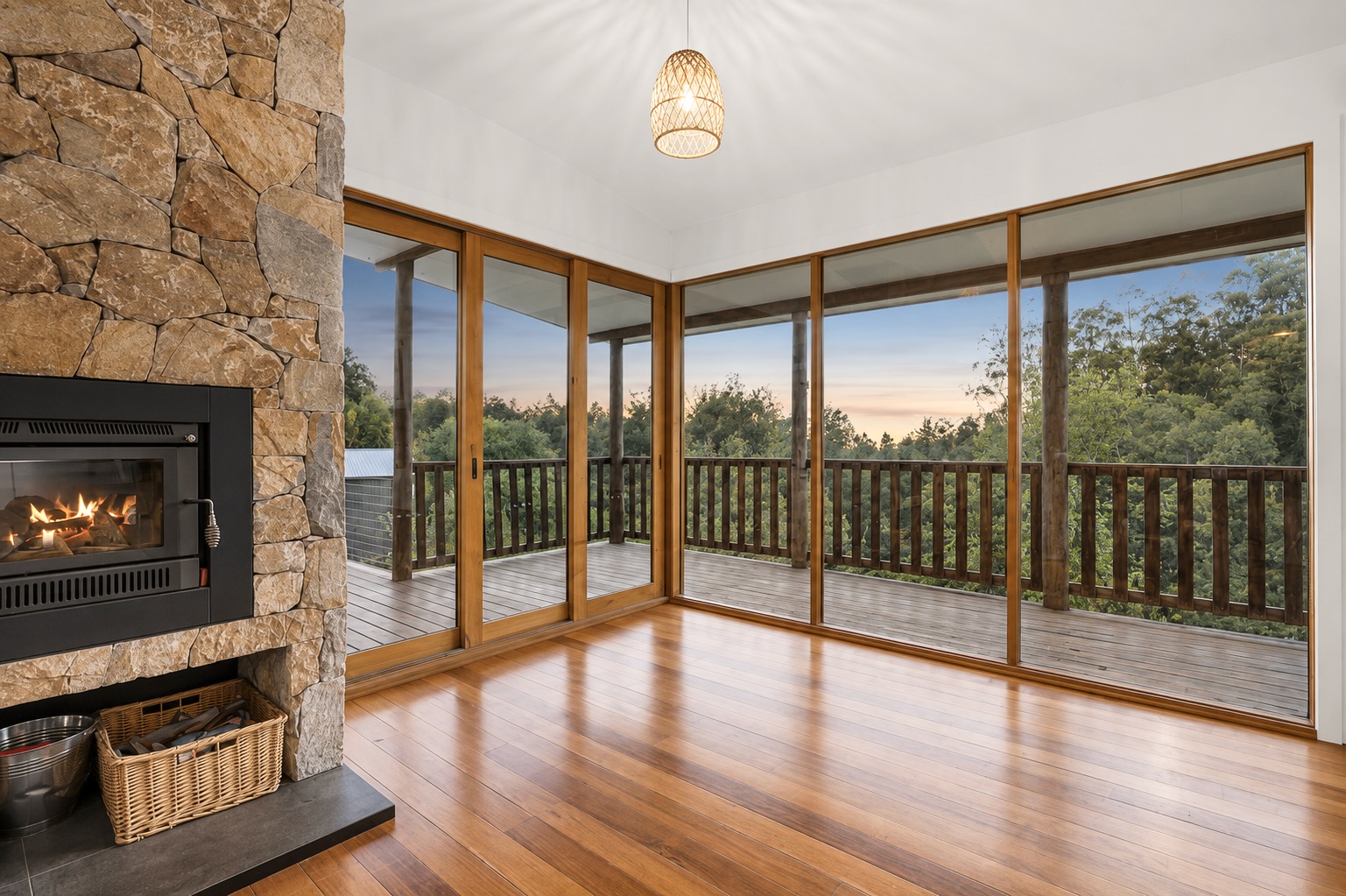 Interior with large timber-framed windows and fireplace