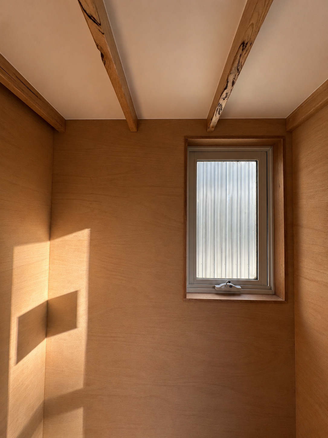 Warm plywood interior of a sustainable tiny home